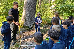 Förster Leo zeigte den Junglöwen, wie mithilfe eines Zollstocks die Höhe eines Baumes bestimmen werden kann. Foto: Privat